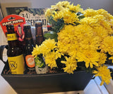 Black faux leather gift basket with flowers, assorted NW microbrew bottles, dog toy, gardening book.
